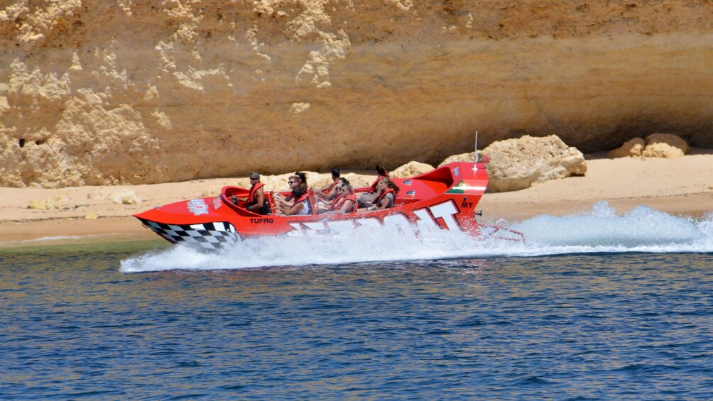 Jetboat just off the coast near a sandy beach in Algarve