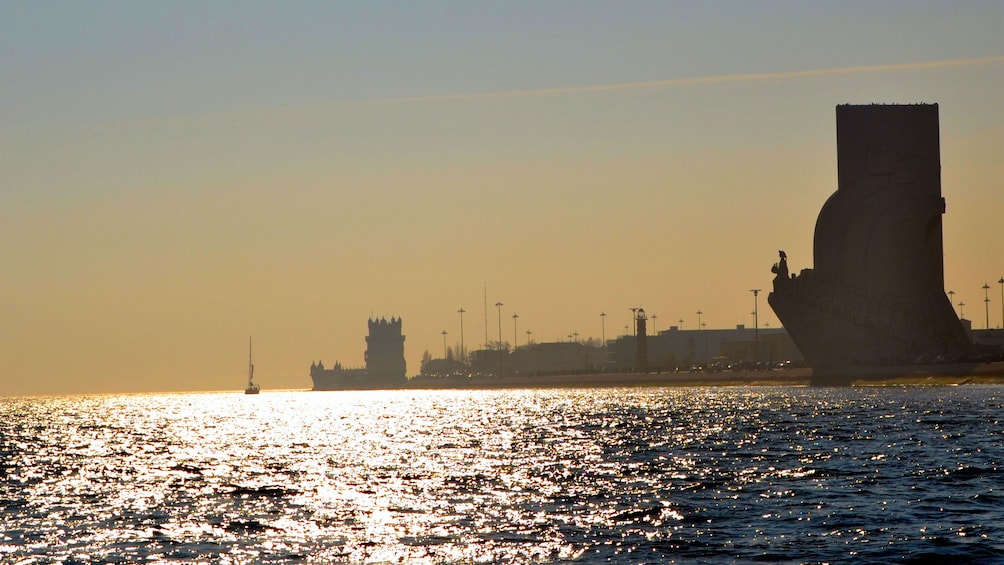 Silhouettes of the Monument to the Discoveries and Belem Tower on the Tagus RIver in Lisbon