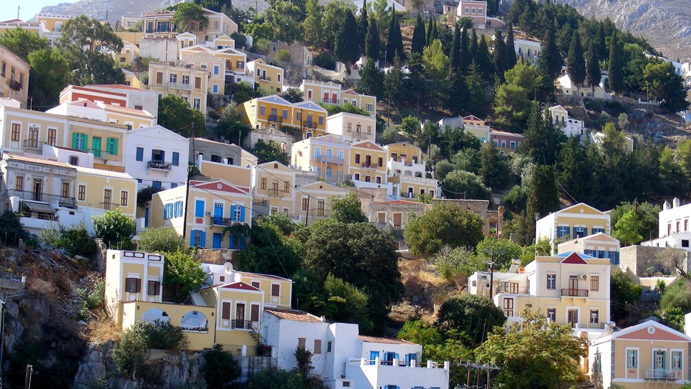 residential homes built into the mountainside in Symi Island