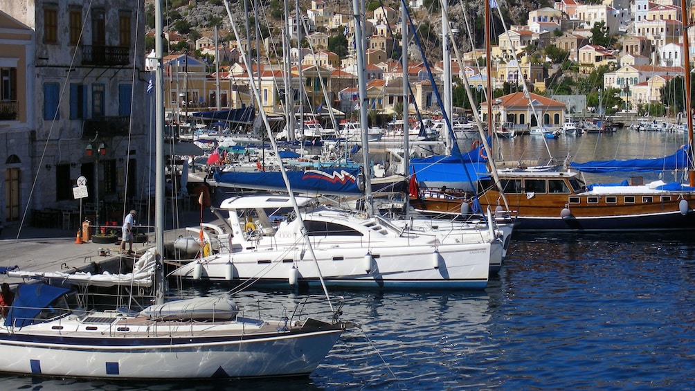 boats docked along the bay in Symi Island