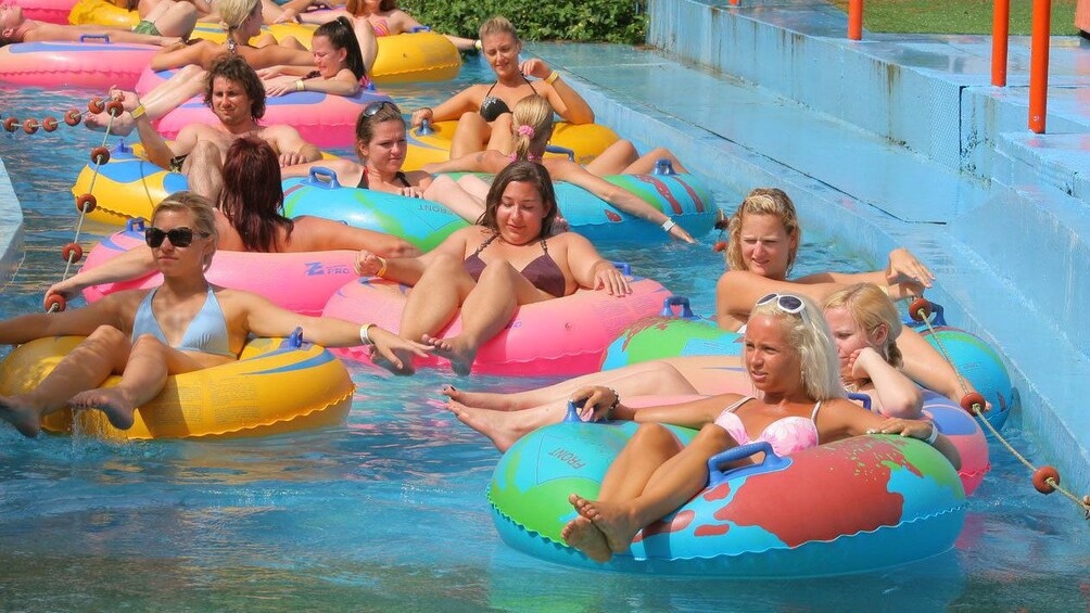 group of women leisurely floating along a course at the waterpark in Greece