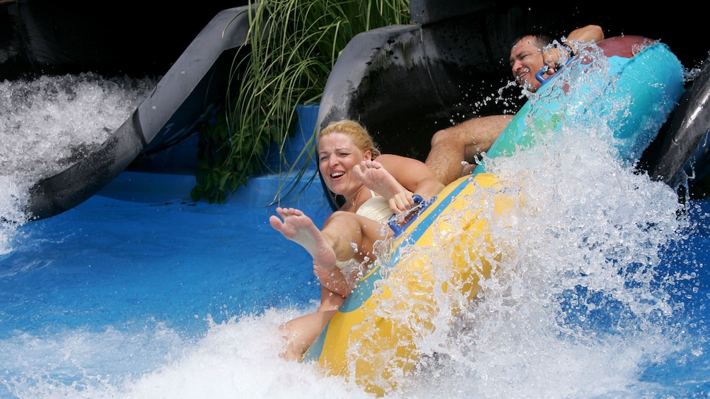 couple at the bottom of the water slide at the waterpark in Greece
