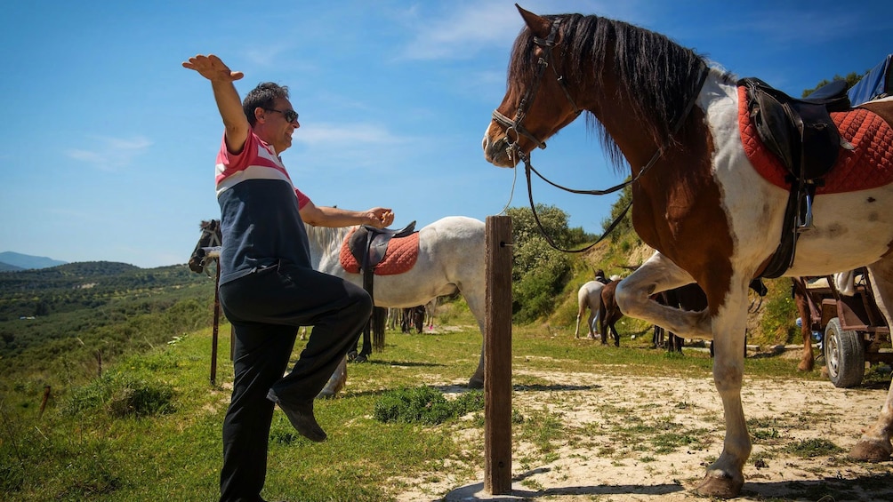 man performing tricks with a horse in Crete