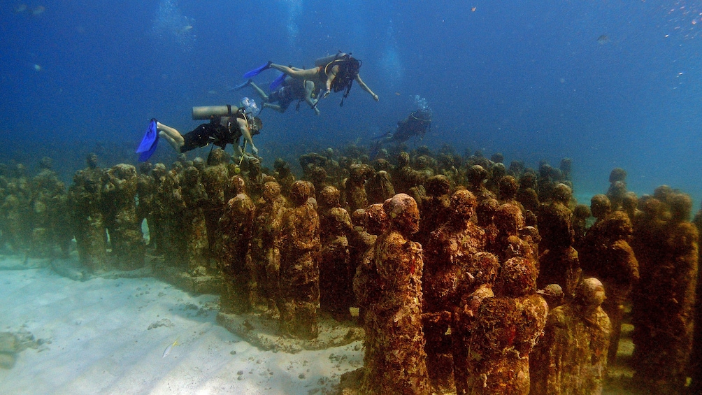 Diving along underwater statues in Mexico