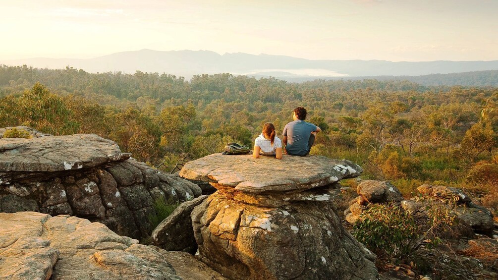 Show item 3 of 10. Couple sitting on mushroom shaped rocks at Grampians National Park