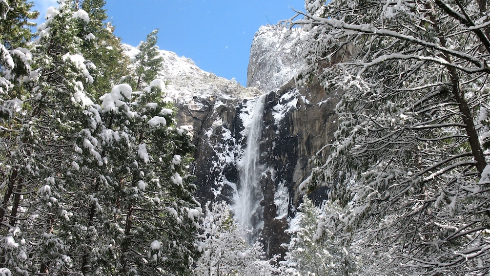 Waterfall, mountains and forest in winter at Yosemite National Park