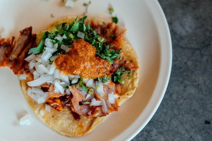 Visit traditional spots for taco vendors with a local
