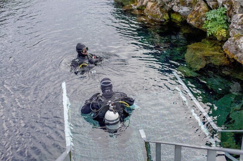 Scuba diver emerging into Silfra