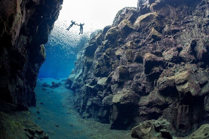 Two snorkelers in Silfra seen from below