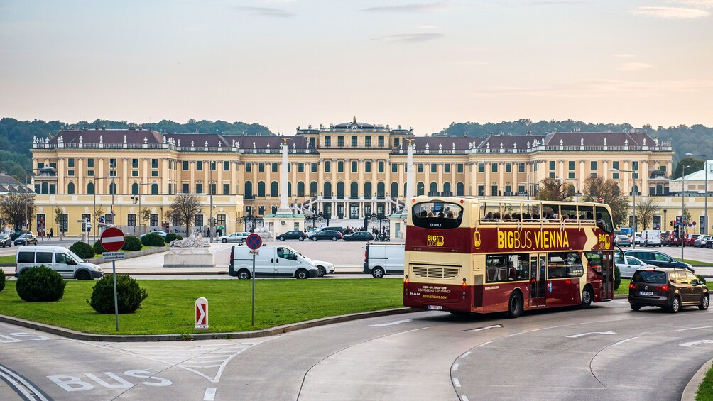 Hop on Hop off bus driving past a historical building in Vienna