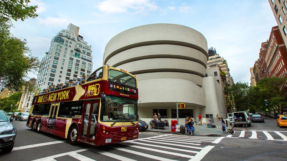 Double decker tour bus driving past the Guggenheim in New York City