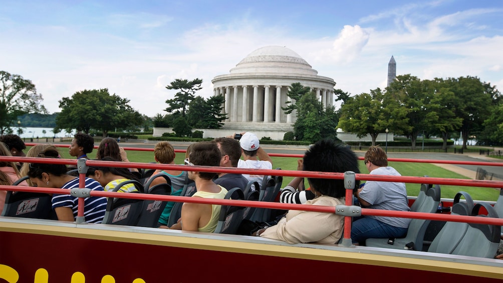 Double decker bus driving past the Jefferson Memorial in Washington DC