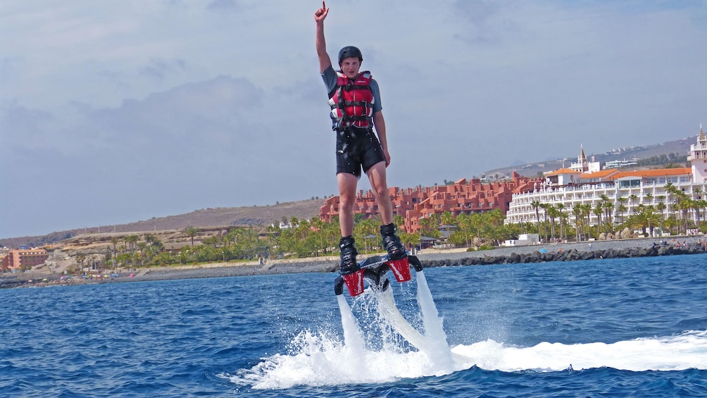 Flyboarding man shoots into the air from the water in Tenerife