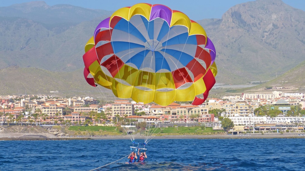 Parascending coasting into the water in Spain