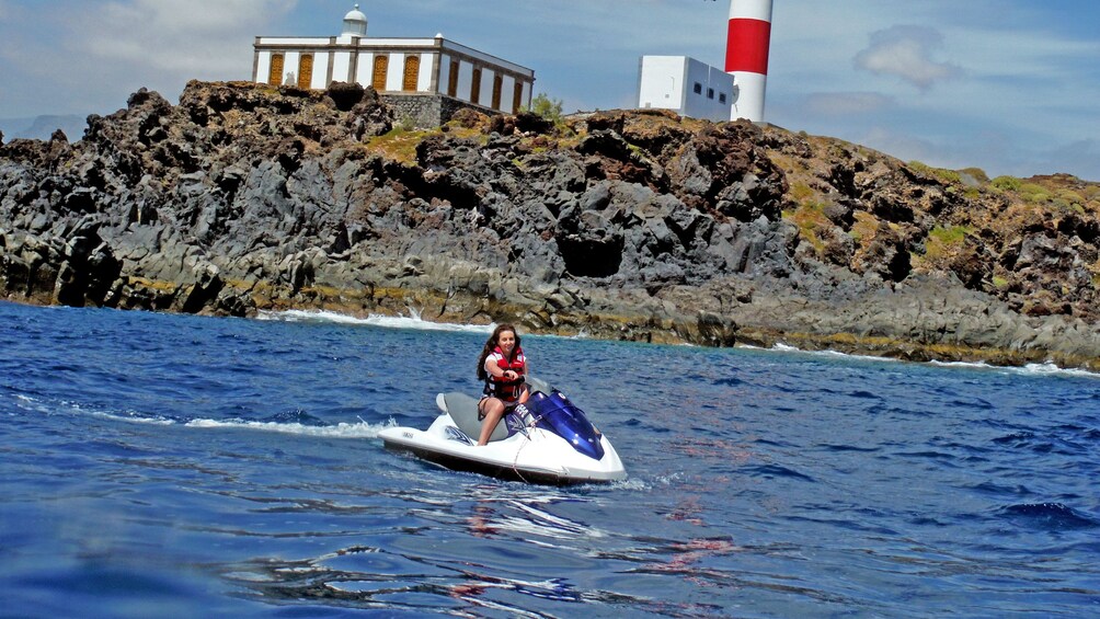 Jet skier near a lighthouse in Spain