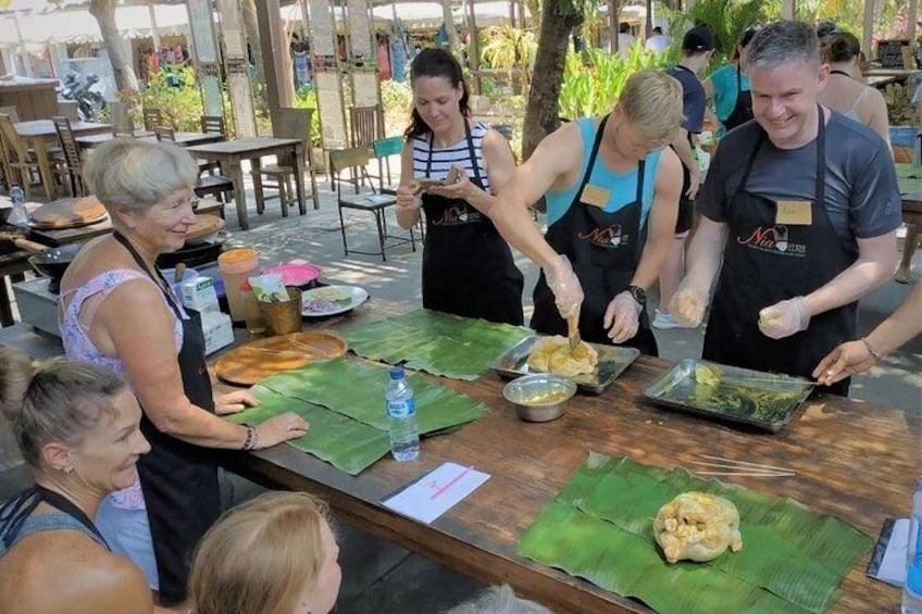 Preparing Ayam Betutu in banana leaves