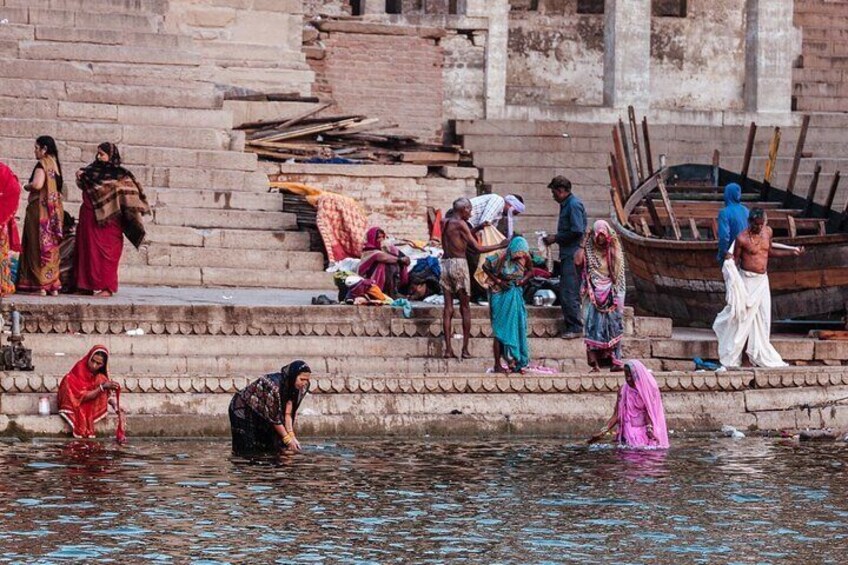 Devotees descend the stairs to wash away their sins