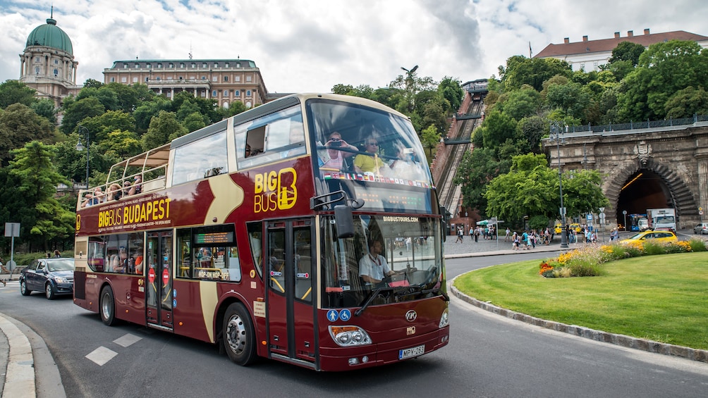 Hop on Hop off bus driving past a historical site in Budapest