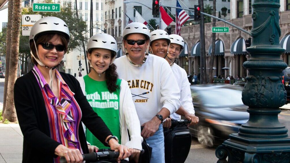group in helmets riding segways on the streets in Los Angeles