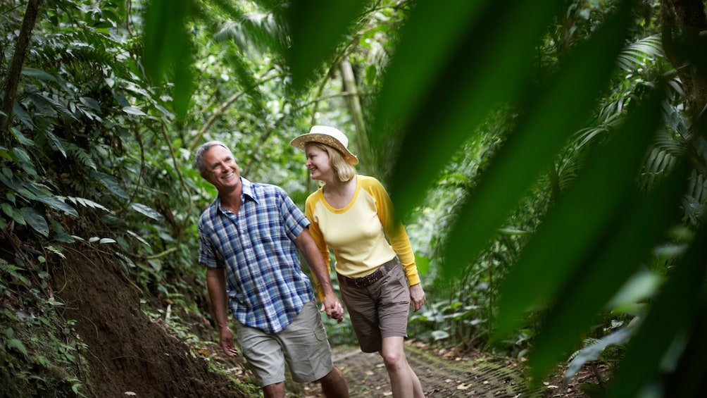 couple walking through a path in the forest in Grenada