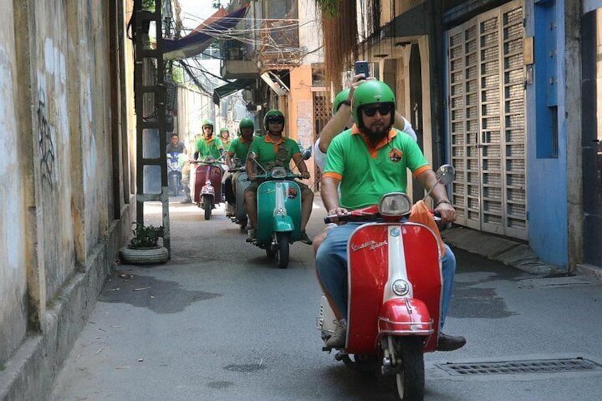 ride vintage vespa pass small alley