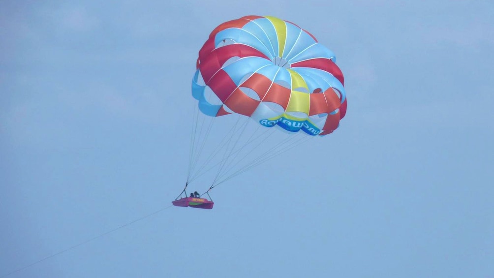 couple parasailing with a small raft in Key West