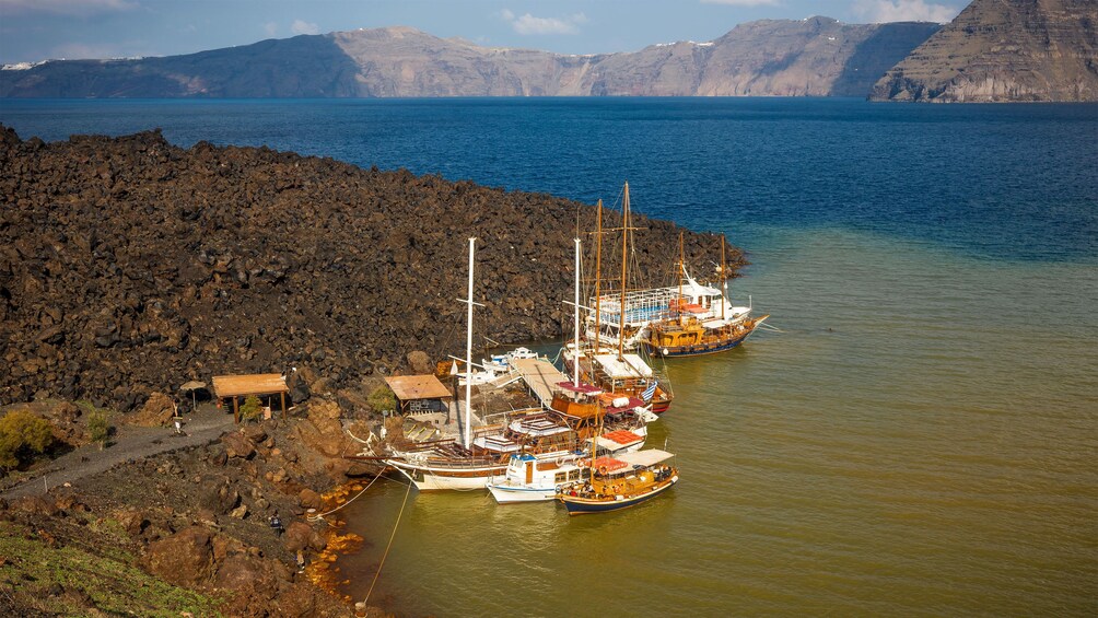 clustered boats along the coastline in Santorini