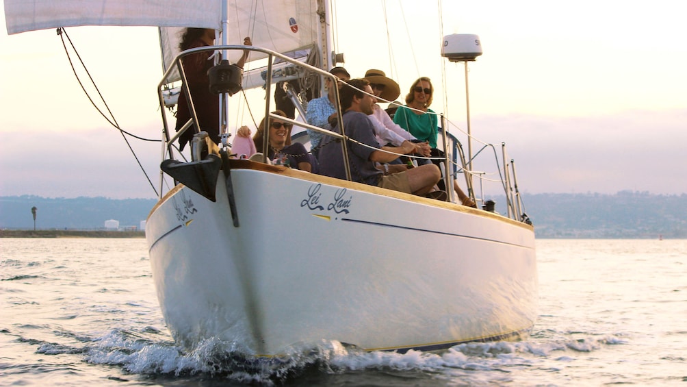 People sitting on bow of boat in San Diego