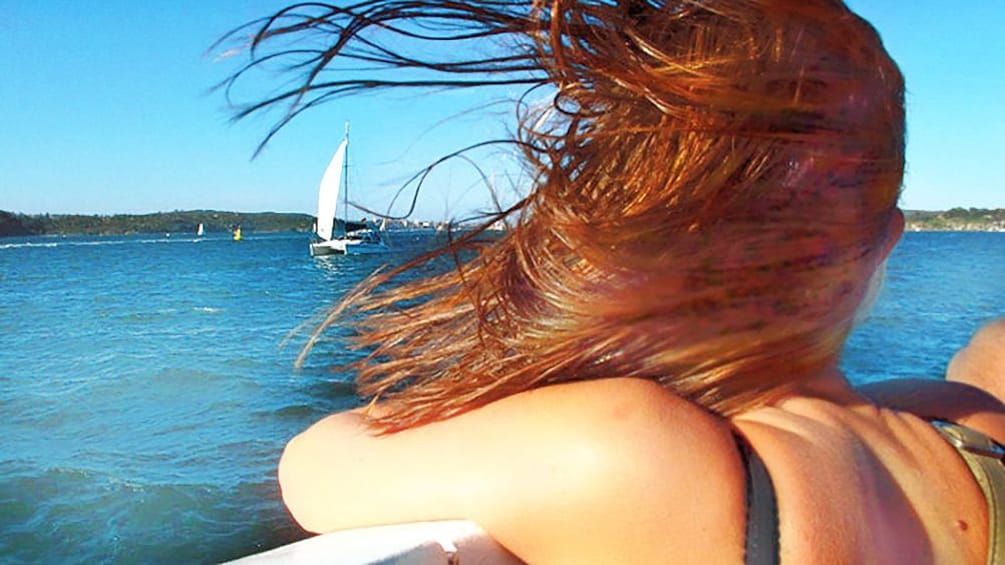 Woman's hair blowing in the breeze on sailboat in San Diego