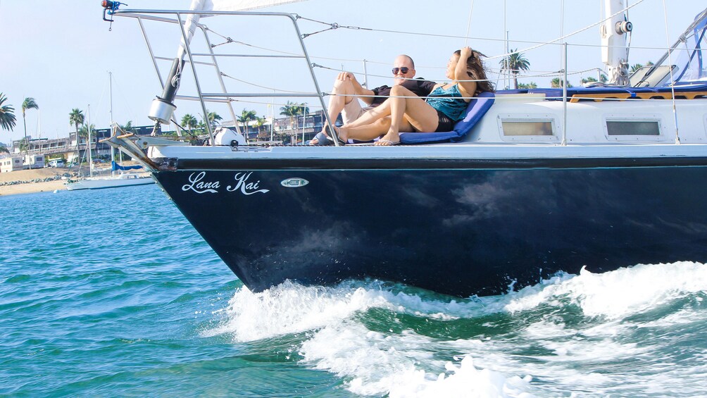 People enjoying sunshine on sailboat in San Diego