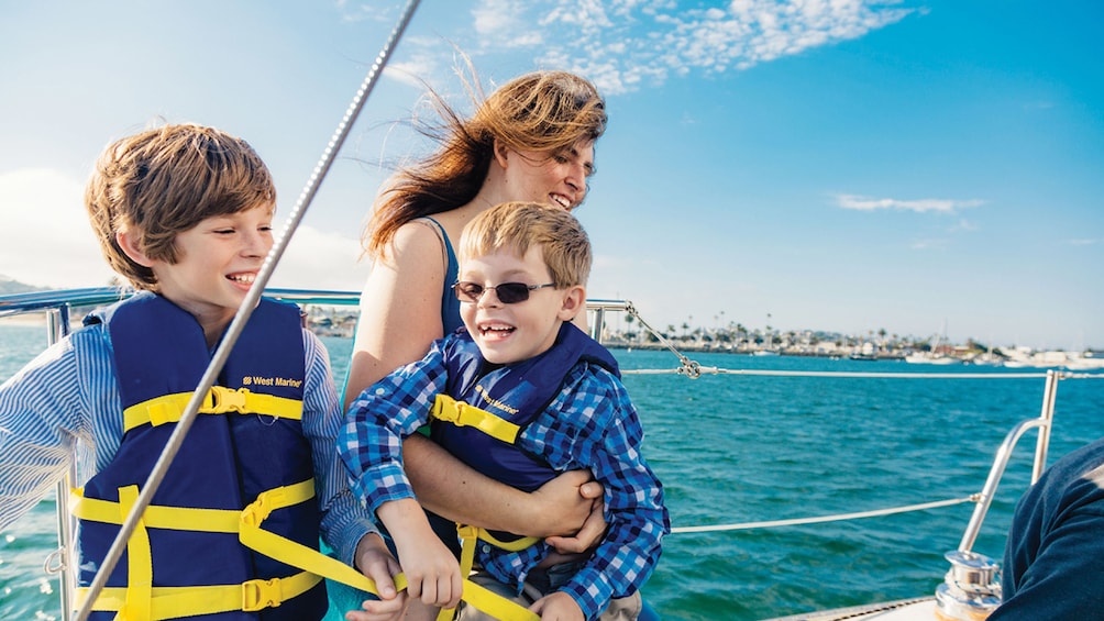 Mother with children on sailboat in San Diego