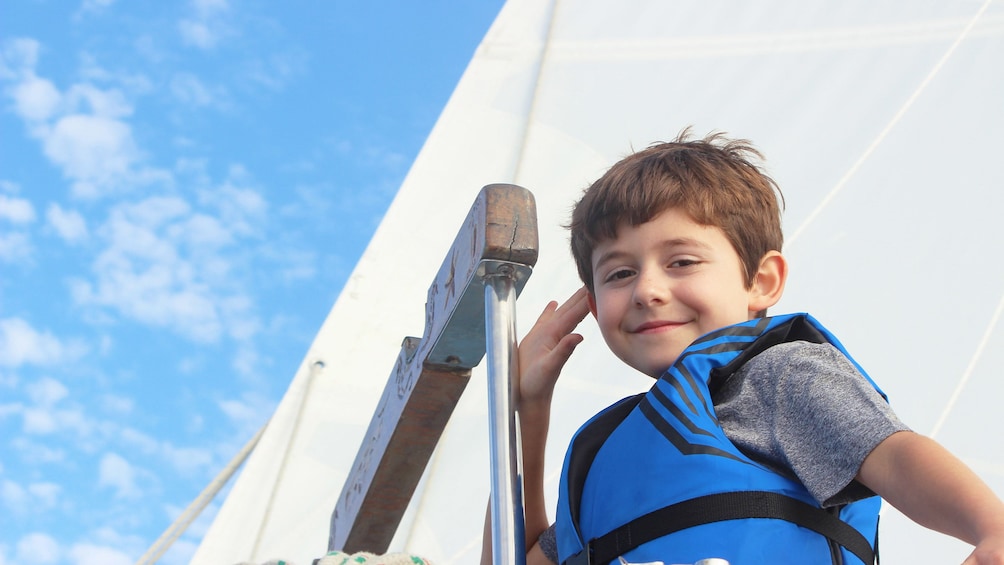Boy smiling on sailboat in San Diego