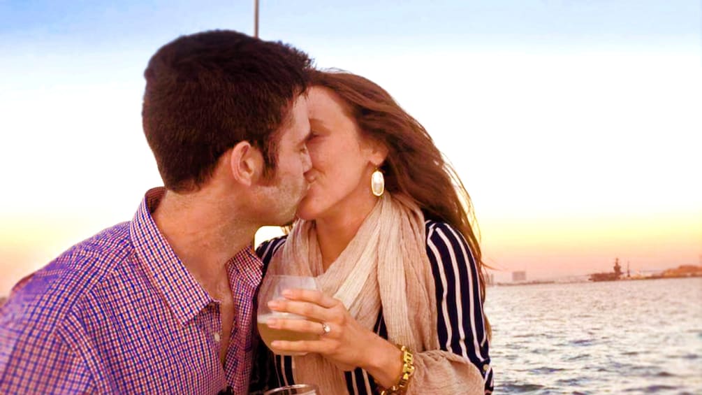 Couple kissing on sunset sail in San Diego
