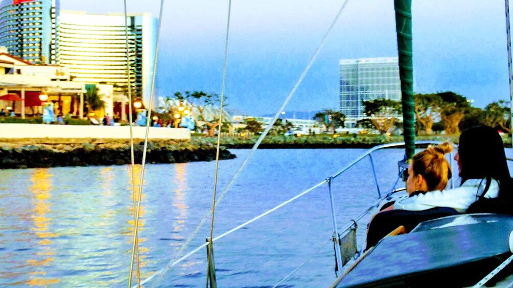 Two woman looking at cityscape from boat in San Diego
