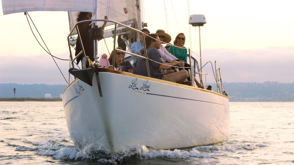 People looking out over water from sailboat off of San Diego