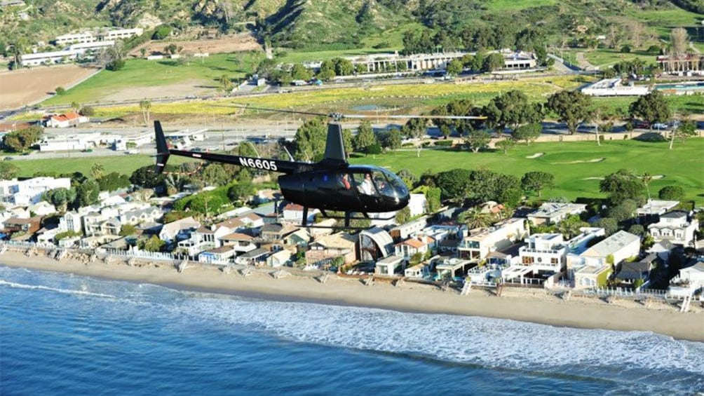 helicopter flying along the sunny beach in Los Angeles