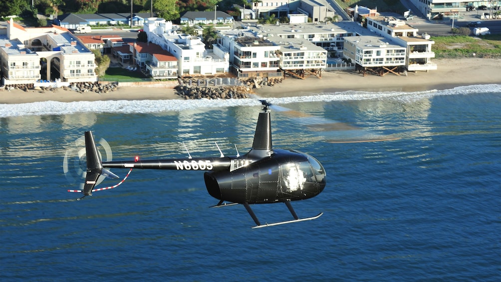 helicopter circling the beach in the morning sun in Los Angeles