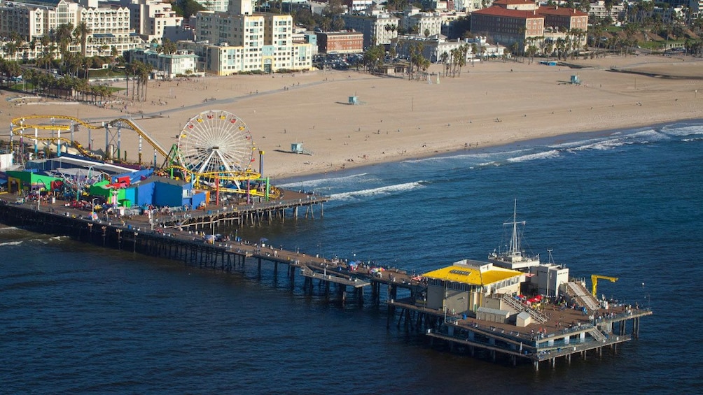 flying above a small theme park at the beach in Los Angeles