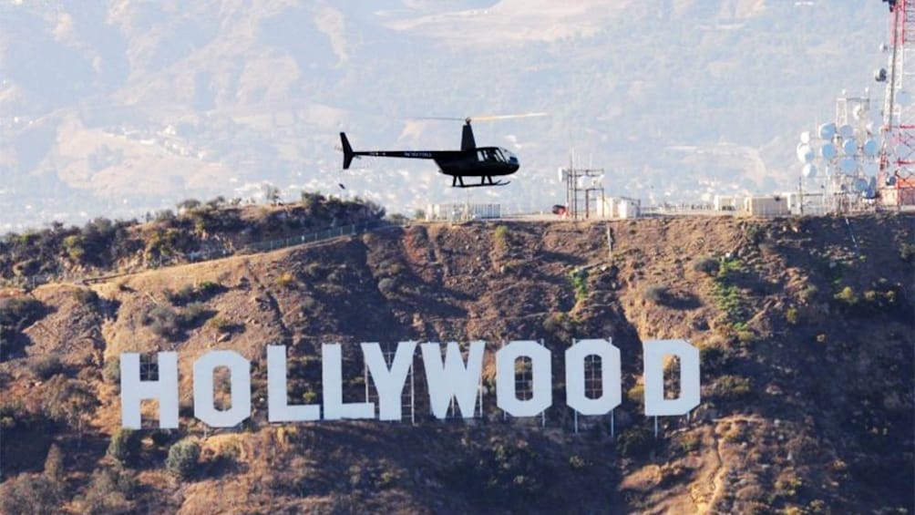 Helicopter hovering over Hollywood hill in Los Angeles