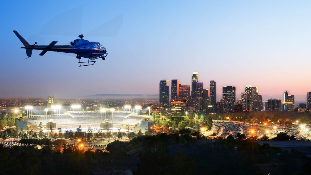 helicopter flying by a sports stadium during the evening in Los Angeles