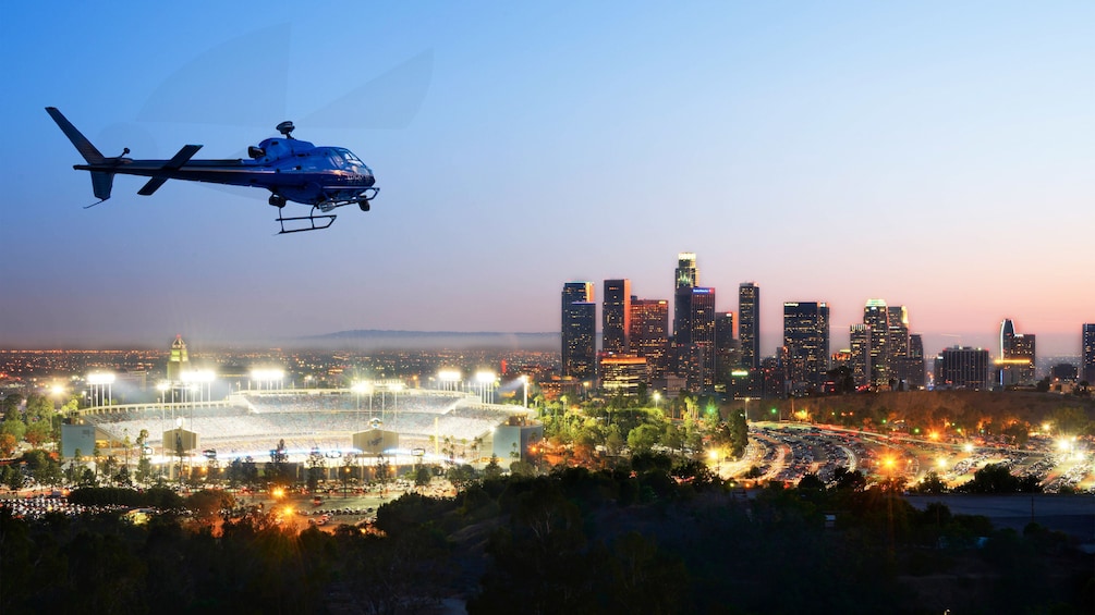 Helicopter flying over the city of Los Angeles on a lit night 