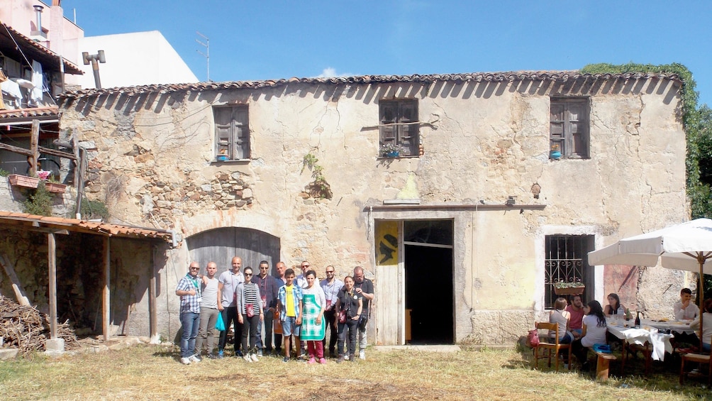 Tour group taking a picture in front of the wine cellar in Cagliari