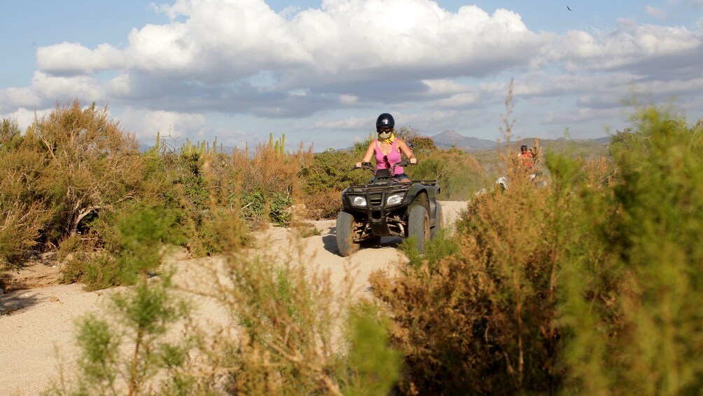 ATV rider on sandy trail