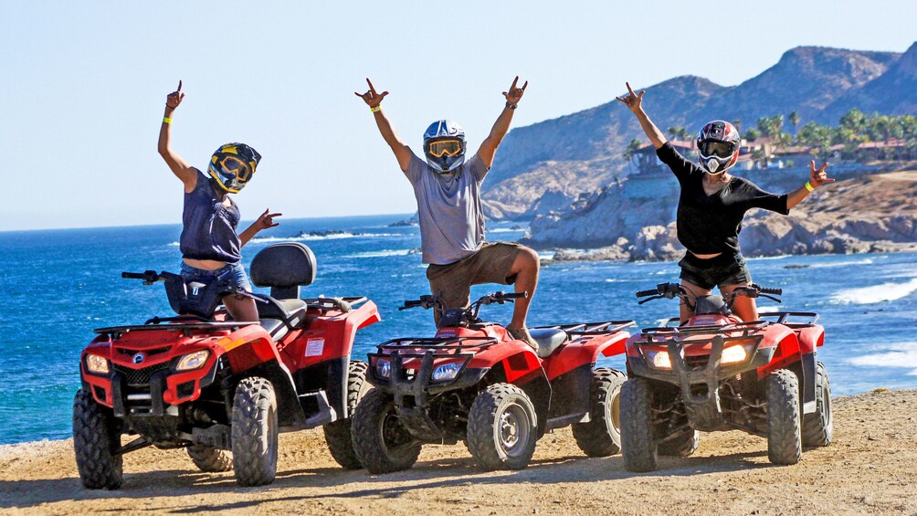 ATV riders cheering at the beach in Los Cabos