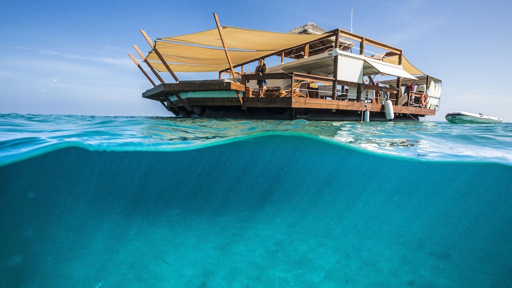Cloud 9 floating cabana docked in a clear blue sea