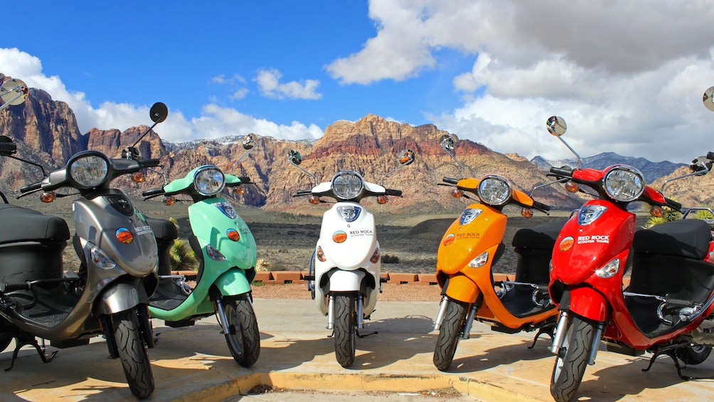 Colorful scooters with mountainous backdrop