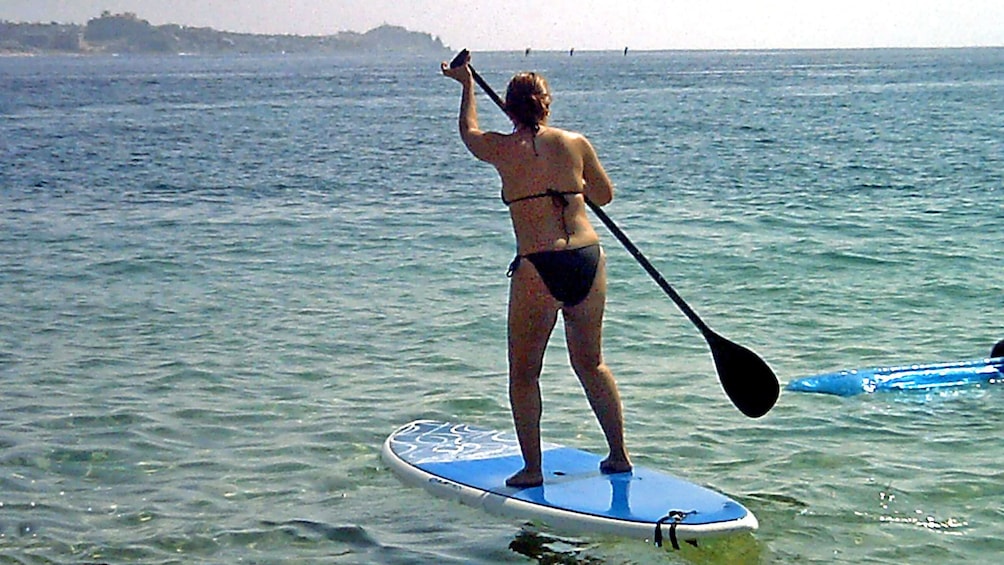 Woman paddle boarding in Los Cabos