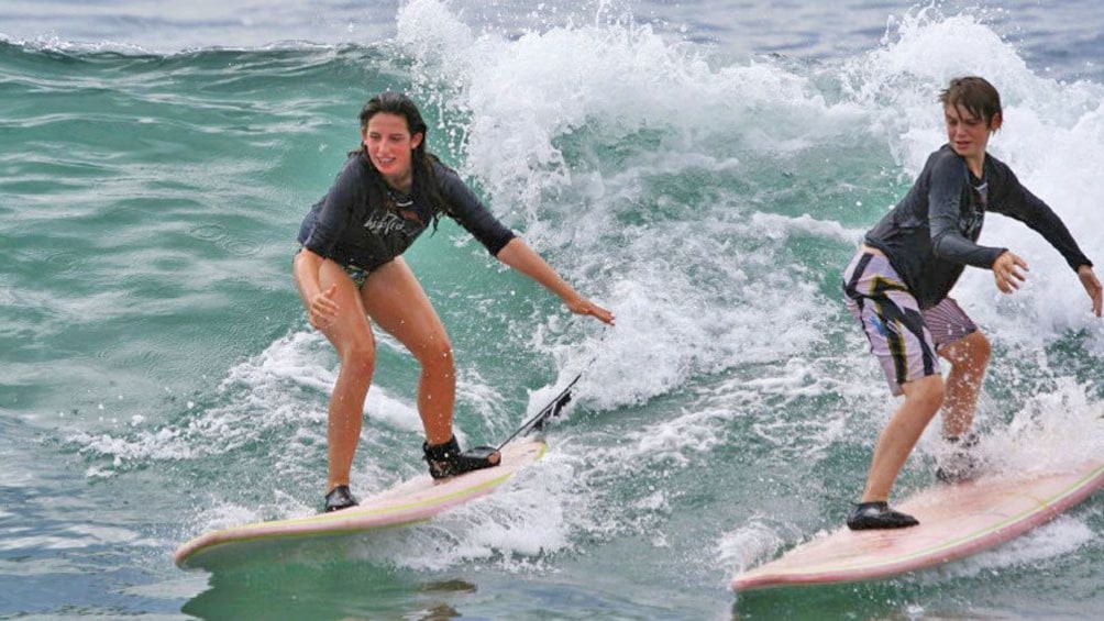 Show item 1 of 10. Teenagers surfing in Los Cabos