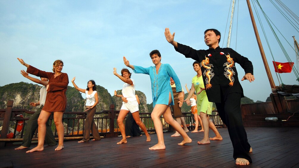 Tai chi lesson on a a boat in Halong Bay