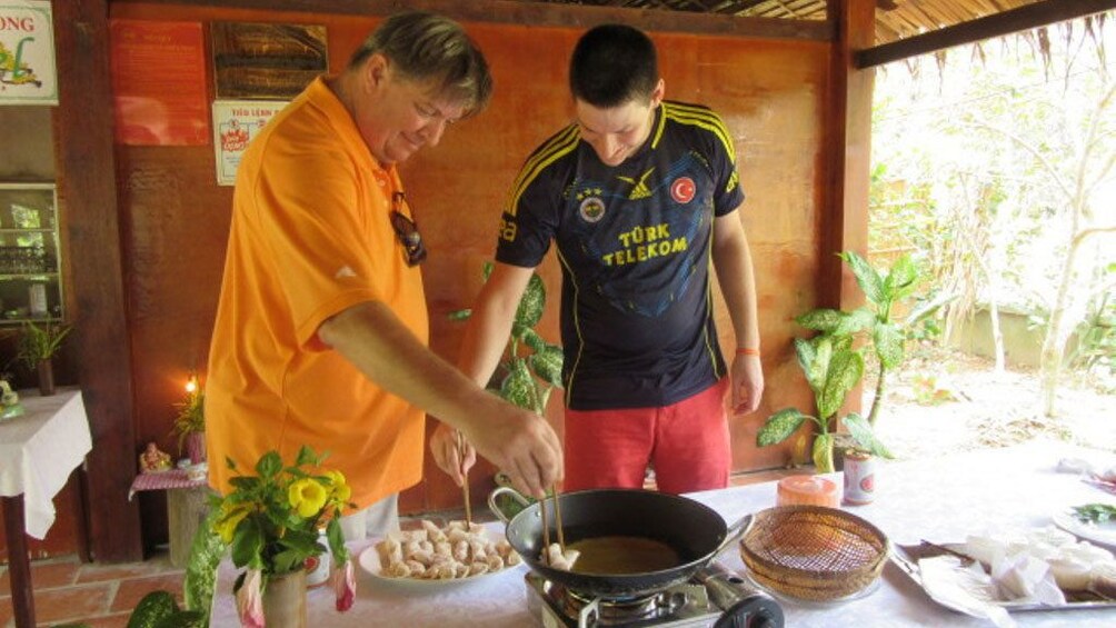 Pair of men preparing Vietnamese food in Mekong